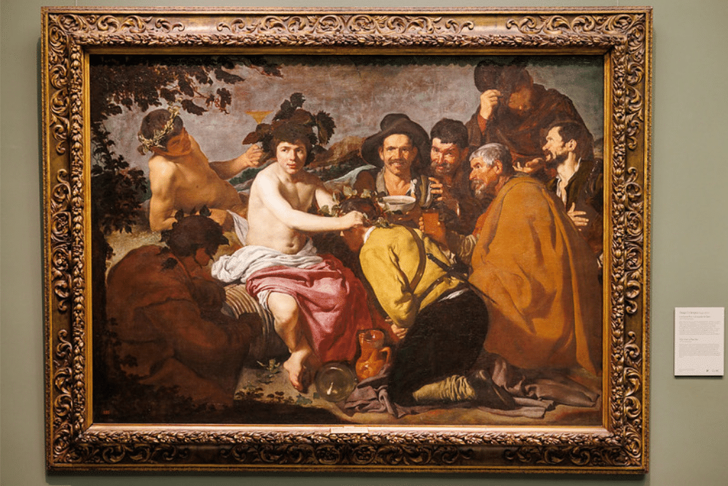 "El Triunfo de Baco de Velázquez, obra maestra del barroco que representa al dios Baco rodeado de borrachos, en el Museo del Prado."